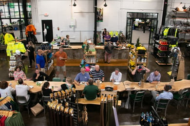 Employees from Bartlett gathered around a table in the Arborwear HQ for a recent conference. 